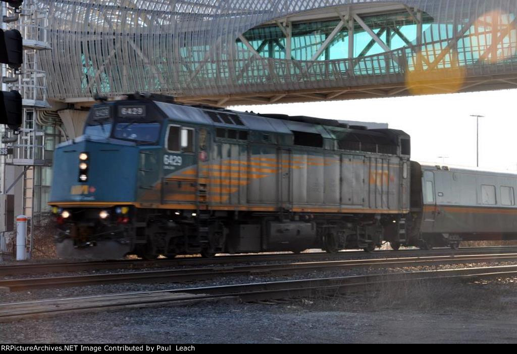 Passenger train cruises east past the station